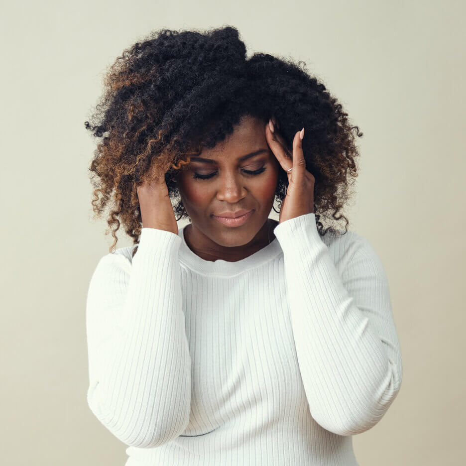 RefulHER Wellness Experience before image of woman rubbing her head.